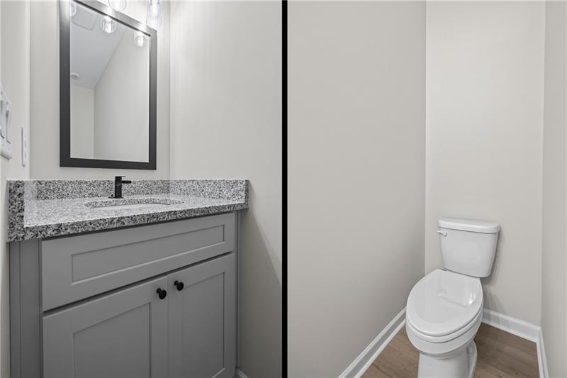 613 Racetrack Road Toccoa, GA 30577 - Photo 23 of 47 a bathroom with a granite countertop toilet sink and mirror