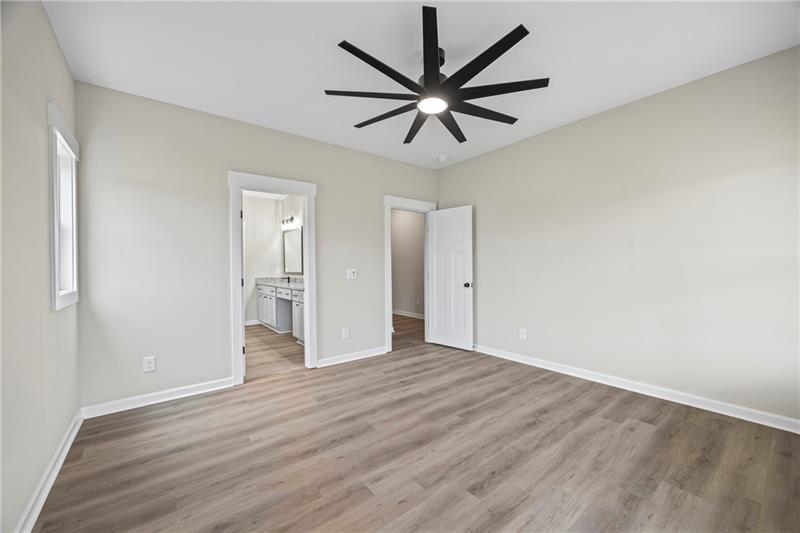 613 Racetrack Road Toccoa, GA 30577 - Photo 26 of 47 an empty room with wooden floor and windows