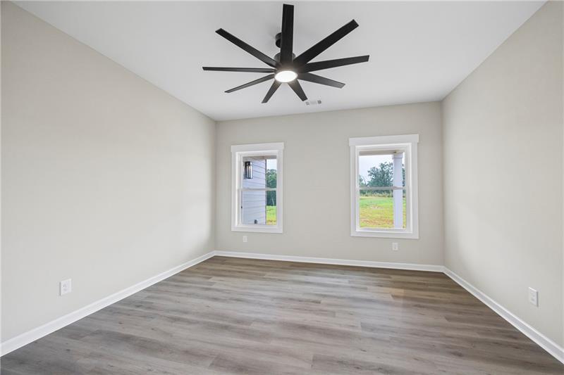 613 Racetrack Road Toccoa, GA 30577 - Photo 27 of 47 an empty room with wooden floor fan and windows
