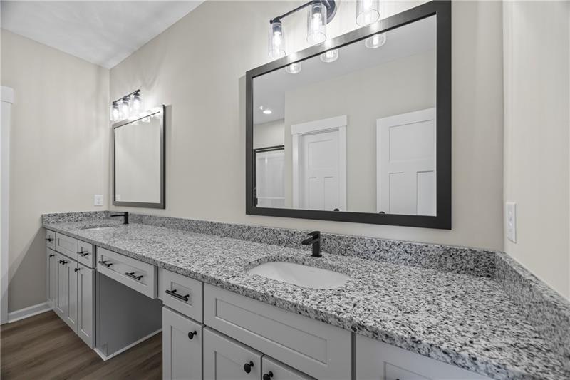 613 Racetrack Road Toccoa, GA 30577 - Photo 29 of 47 a bathroom with a granite countertop sink and a mirror