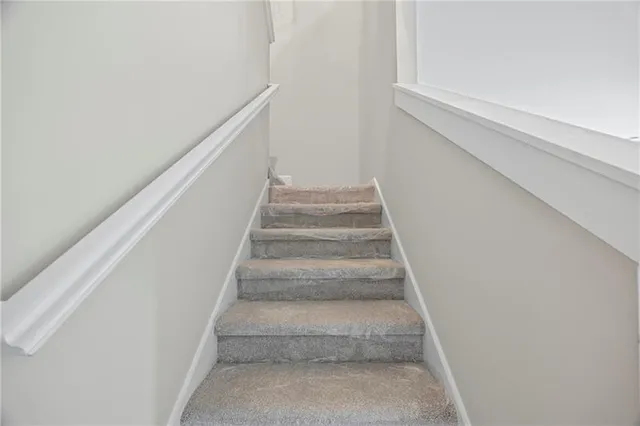 a view of staircase with white walls