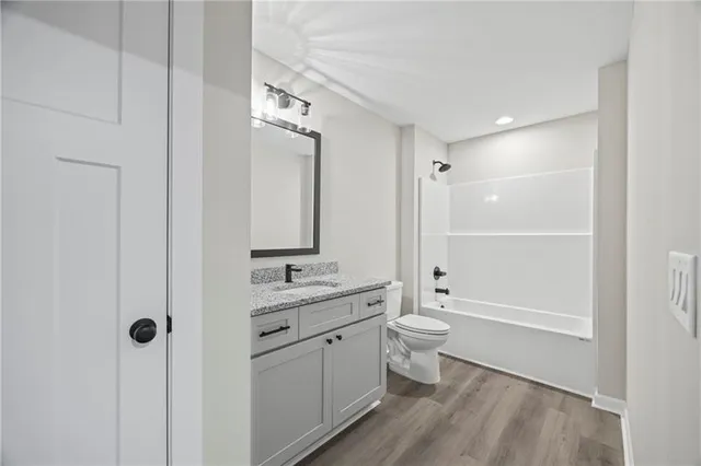 a bathroom with a double vanity sink toilet and shower