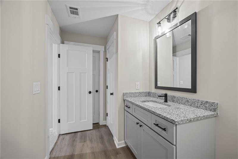 613 Racetrack Road Toccoa, GA 30577 - Photo 40 of 47 a bathroom with a granite countertop sink and a mirror