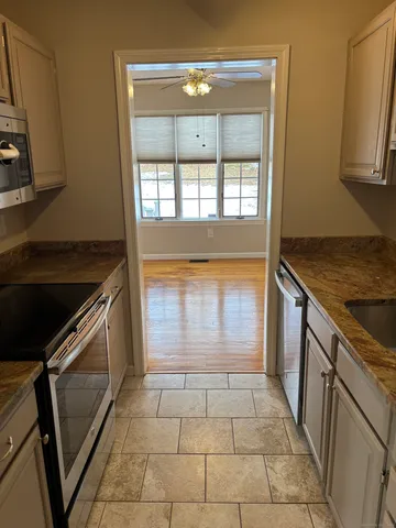 a view of a kitchen with a sink and a stove top oven