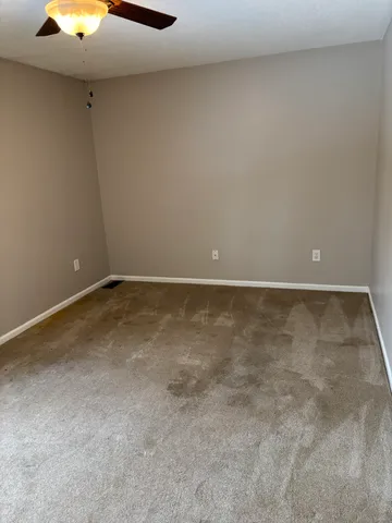 a view of room with a ceiling fan