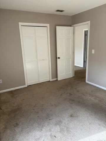 an empty room with closet area