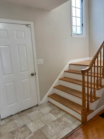 a view of entryway with wooden floor and stairs