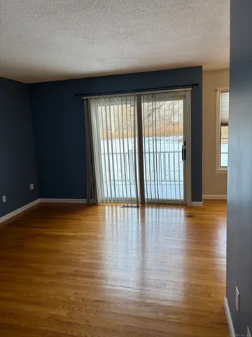 a view of an empty room with glass door