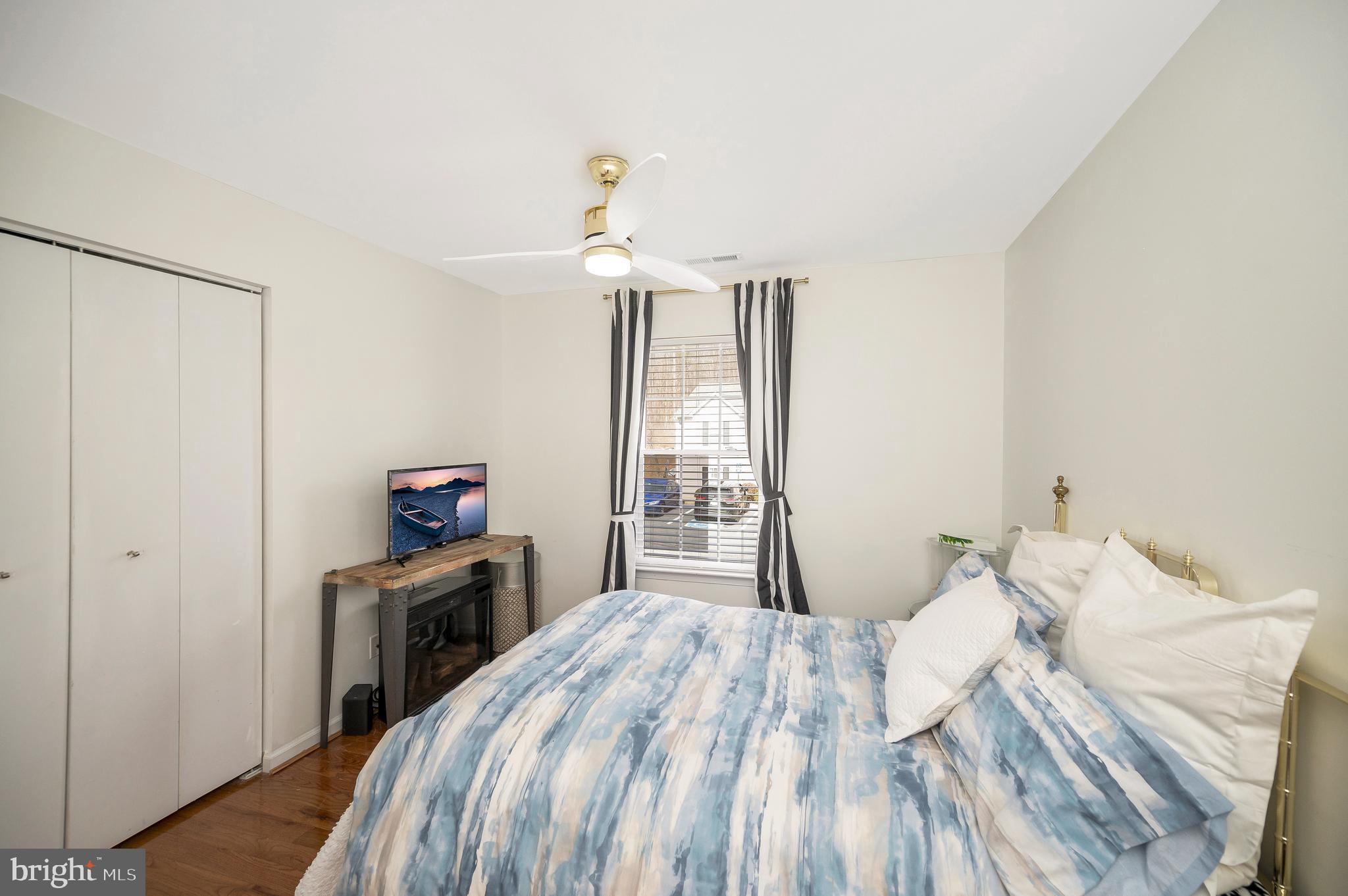 41 Smokewood Court, Unit 200 Stafford, VA 22554 - Photo 14 of 40 a bedroom with a bed and a flat tv screen on a dresser
