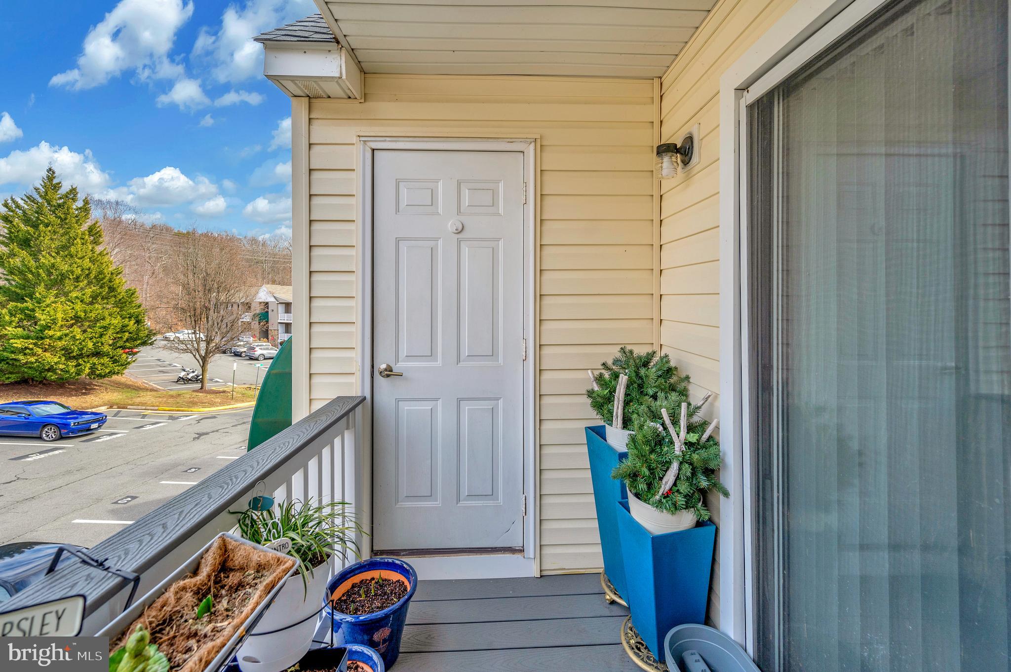 41 Smokewood Court, Unit 200 Stafford, VA 22554 - Photo 20 of 40 a balcony with potted plants on wooden floor