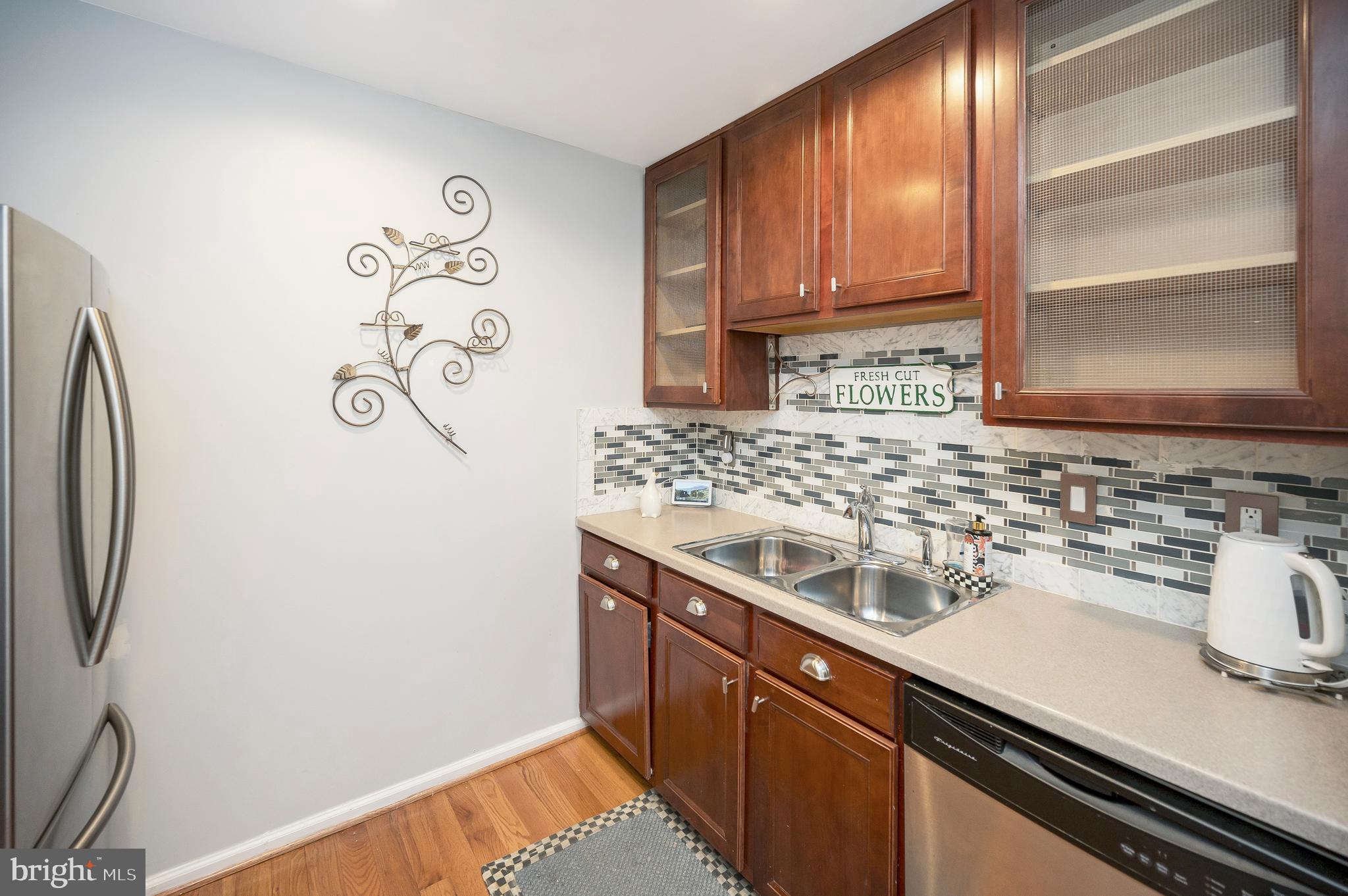 41 Smokewood Court, Unit 200 Stafford, VA 22554 - Photo 25 of 40 a kitchen with a sink and a refrigerator