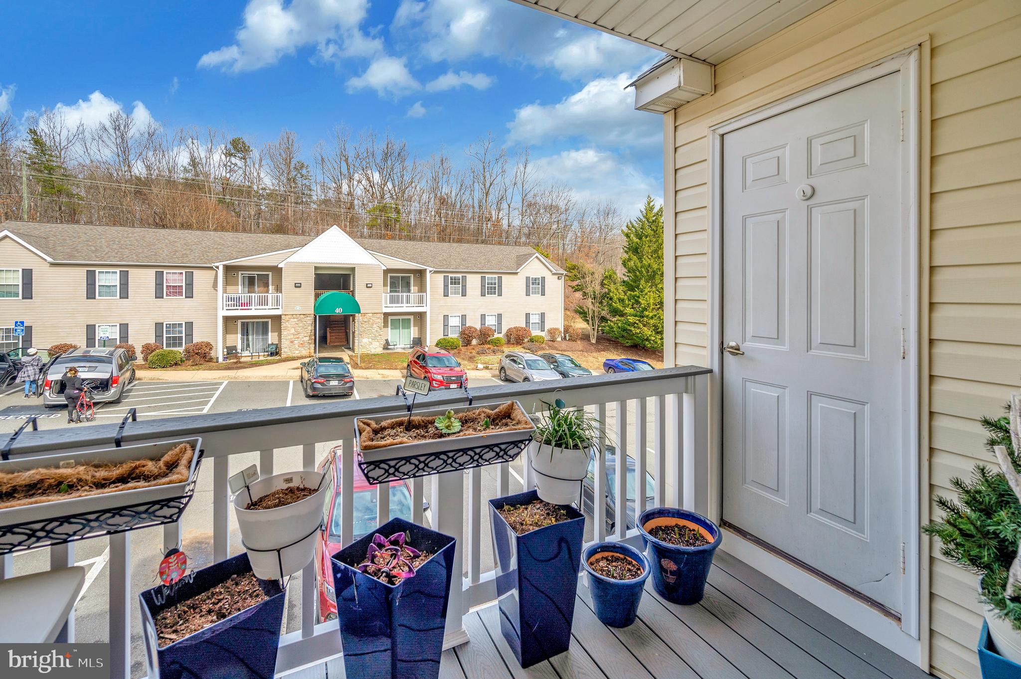 41 Smokewood Court, Unit 200 Stafford, VA 22554 - Photo 8 of 40 a view of a patio with couches and table and chairs and potted plants