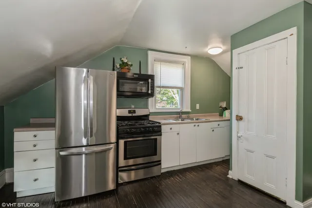 a kitchen with stainless steel appliances a refrigerator sink and cabinets