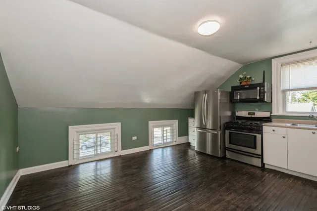 a kitchen with stainless steel appliances granite countertop a stove and a refrigerator