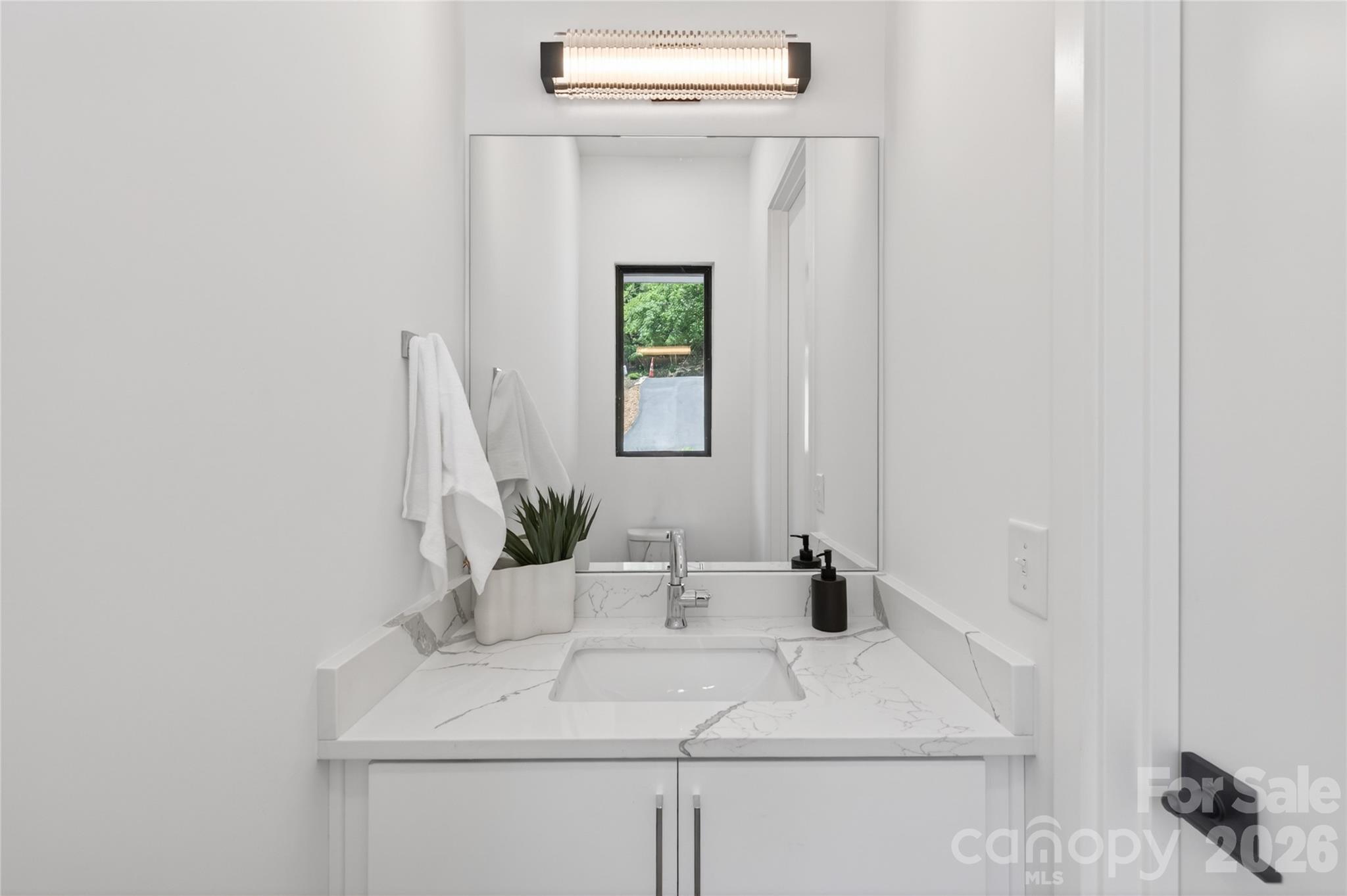 115 High Shores Road Norwood, NC 28128 - Photo 12 of 30 a bathroom with a sink and a mirror