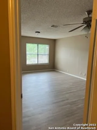 a view of room with window and hardwood floor