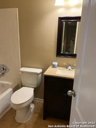 a bathroom with a sink toilet and mirror