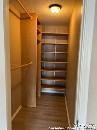 a view of walk in closet with empty racks