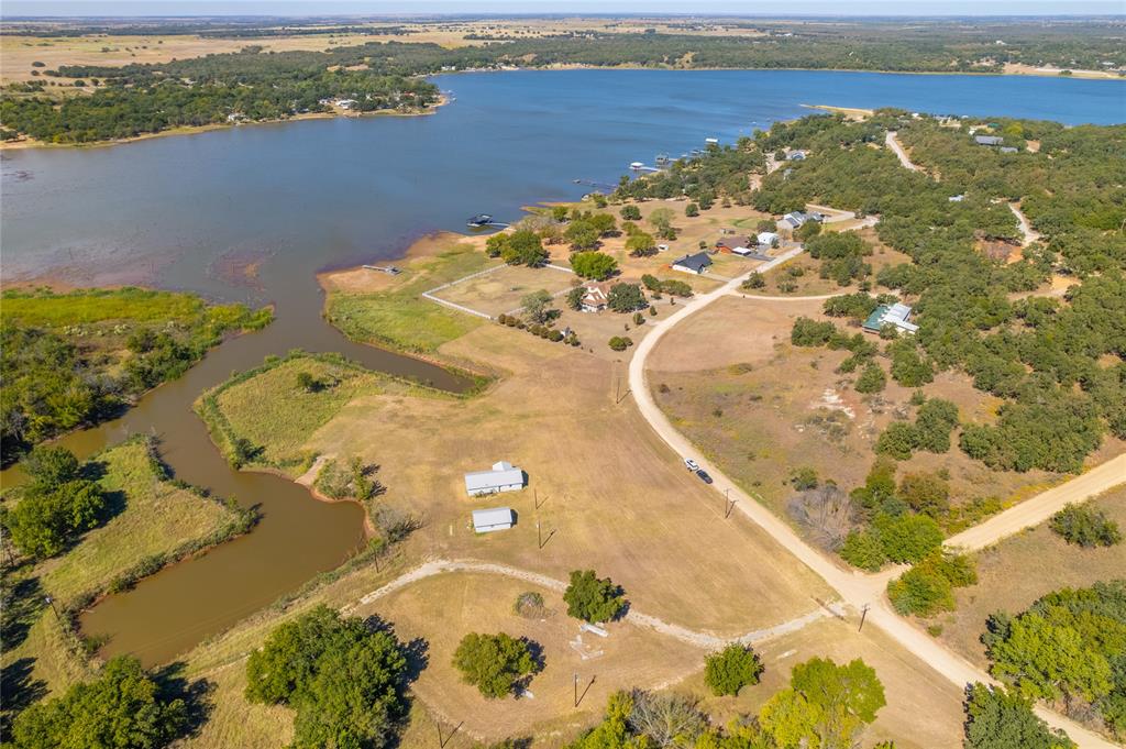 180 Comanche Trail Nocona, TX 76255 - Photo 6 of 8 an aerial view of a house with a lake view