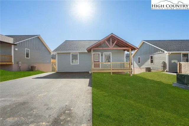 a front view of a house with a garden and yard