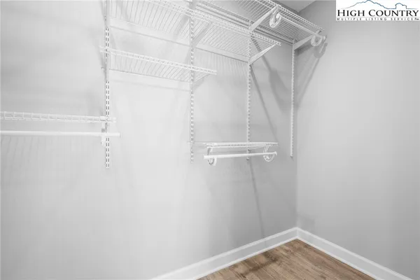 a view of walk in closet with empty racks