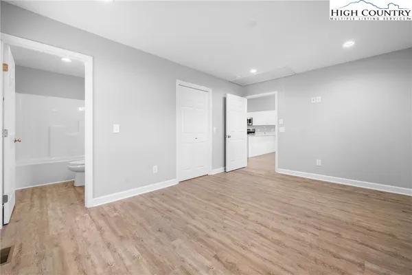 a view of empty room with wooden floor