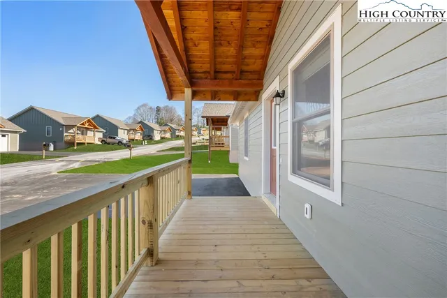 a view of a pathway front a house with wooden fence