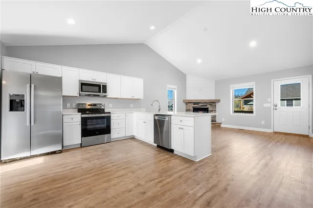 a kitchen with a refrigerator a stove top oven a sink and dishwasher