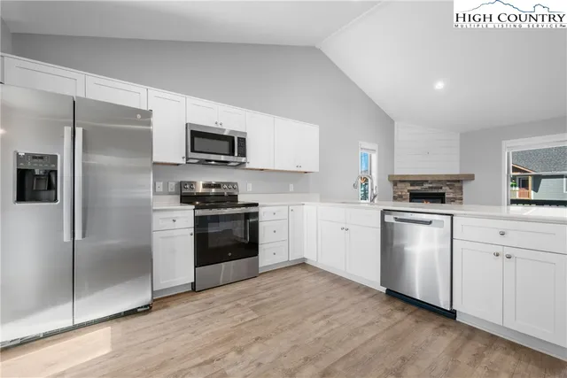 a kitchen with a refrigerator stove and microwave