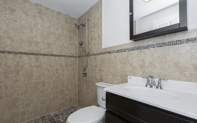 a bathroom with a sink a toilet and a mirror