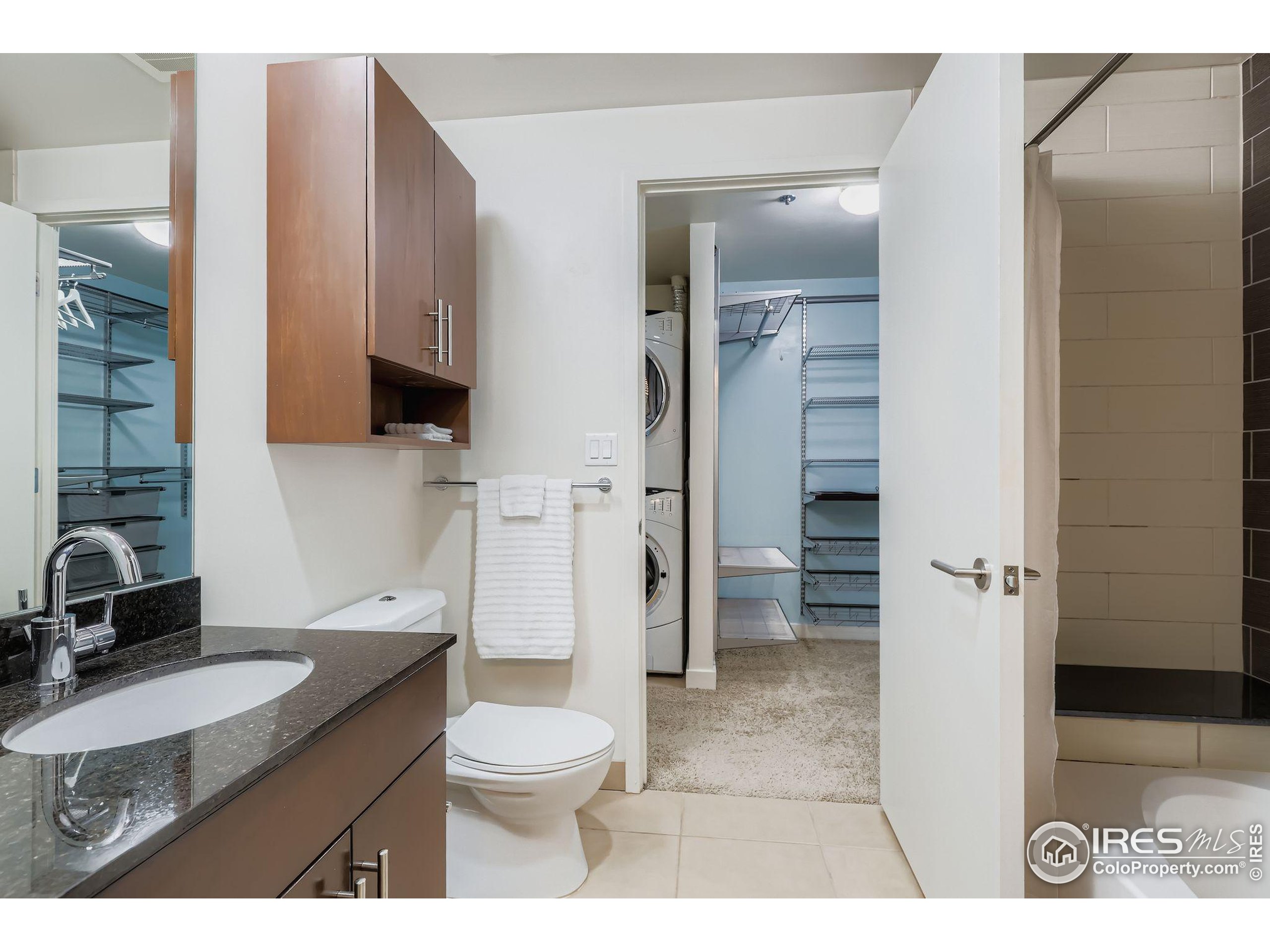 891 14th Street, Unit 1111 Denver, CO 80202 - Photo 13 of 38 a bathroom with a granite countertop sink toilet and shower