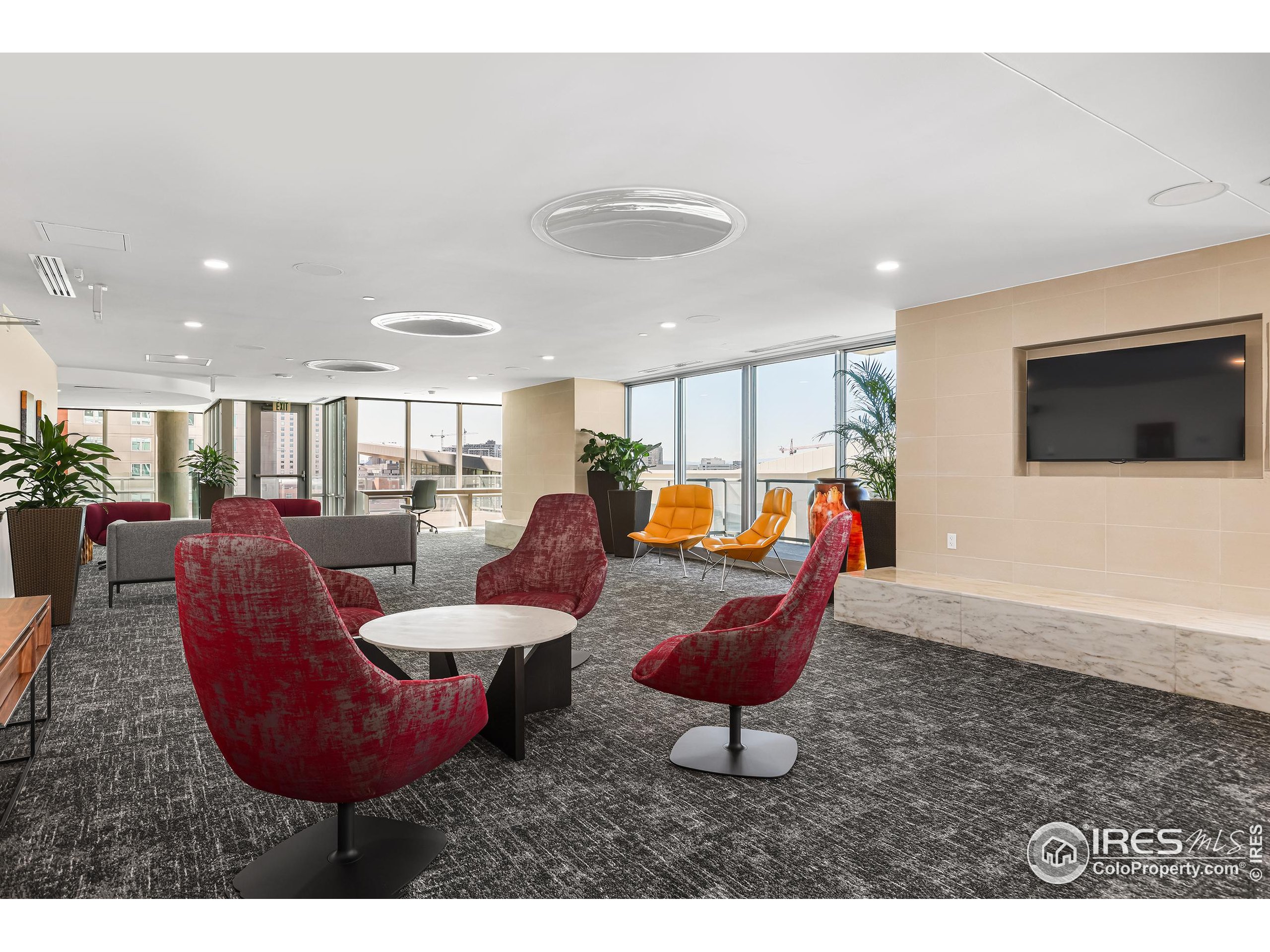 891 14th Street, Unit 1111 Denver, CO 80202 - Photo 30 of 38 a living room with furniture a flat screen tv and kitchen view