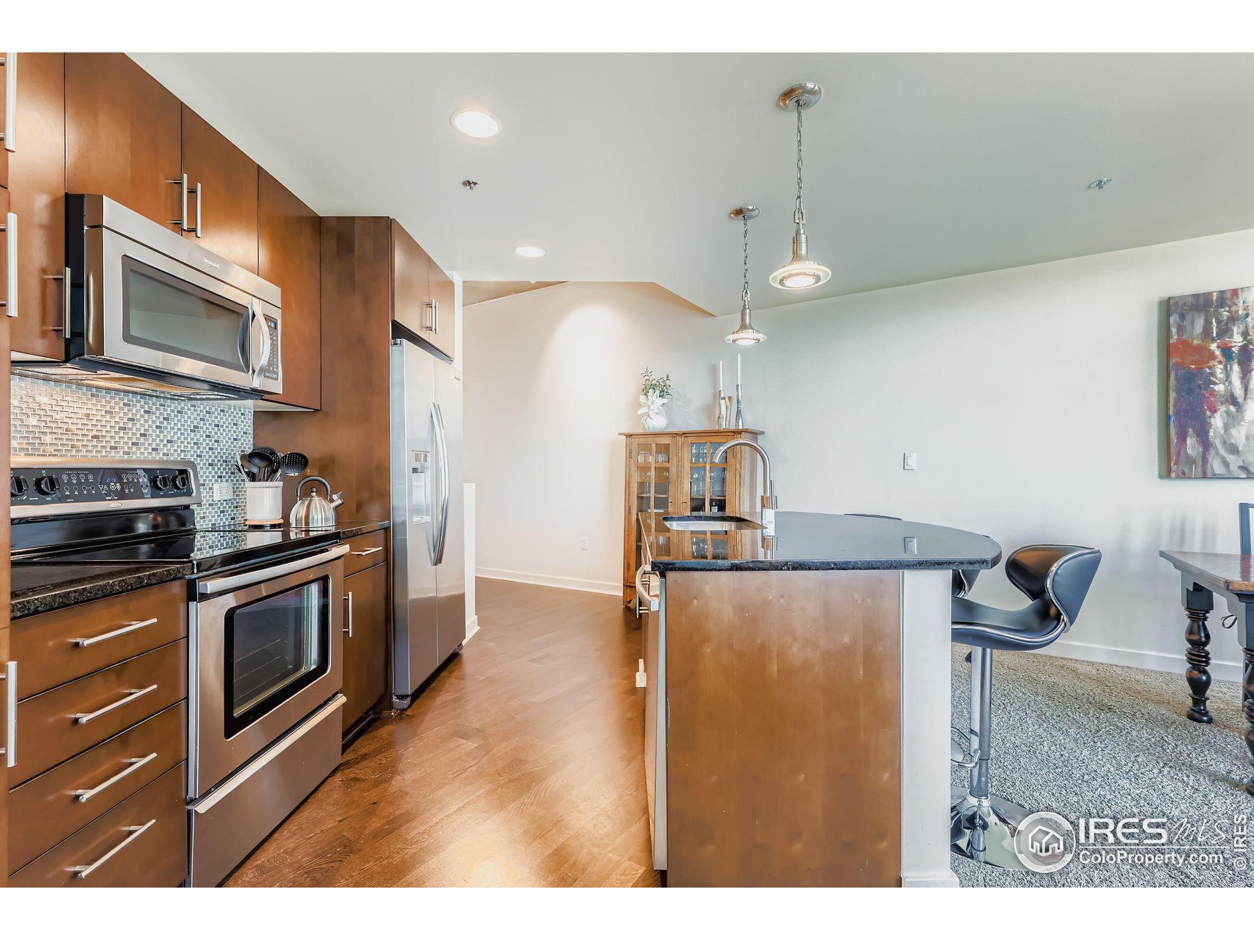 891 14th Street, Unit 1111 Denver, CO 80202 - Photo 5 of 38 a kitchen with stainless steel appliances granite countertop a sink a stove and a microwave