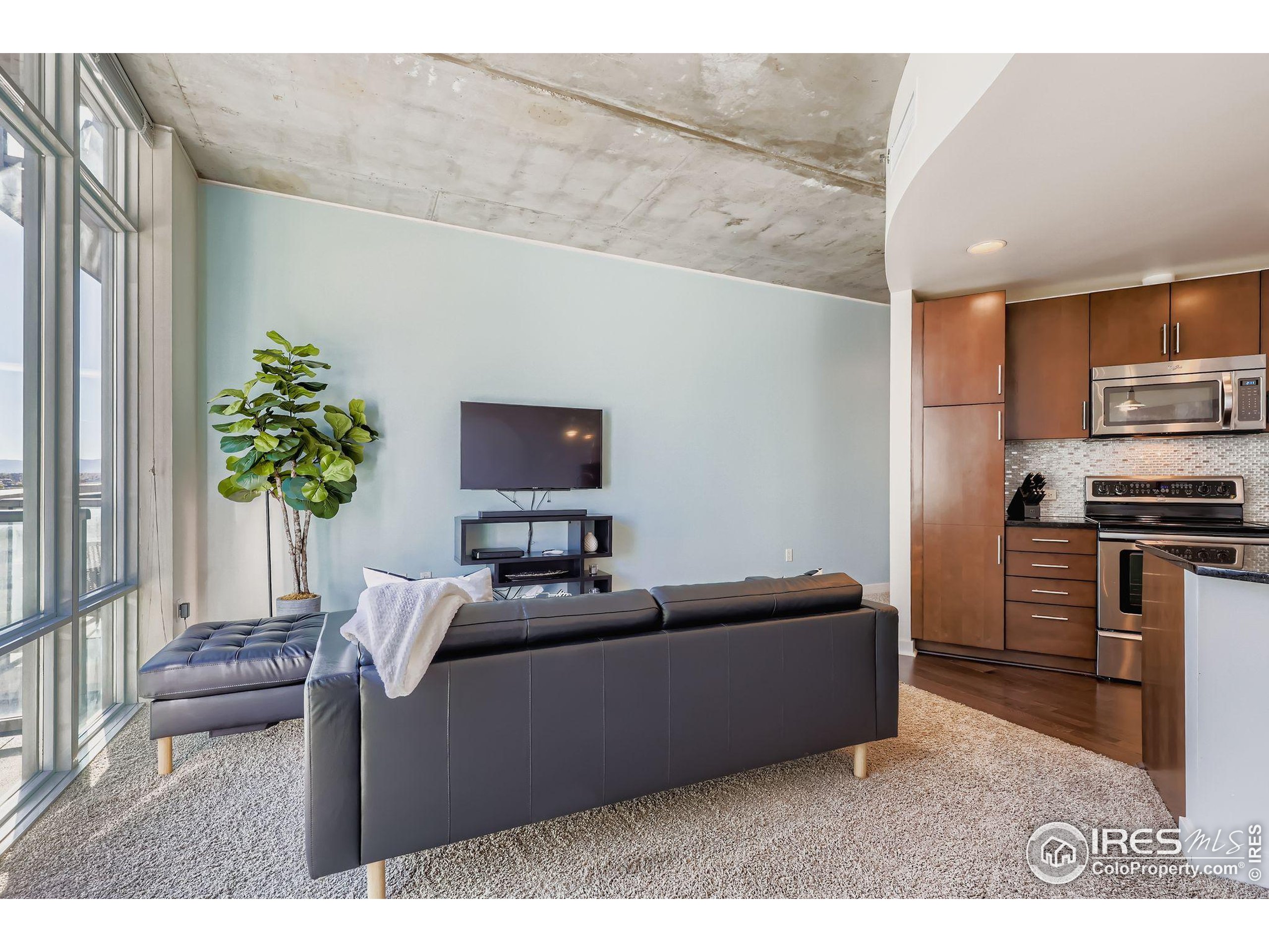 891 14th Street, Unit 1111 Denver, CO 80202 - Photo 7 of 38 a living room with furniture and a flat screen tv