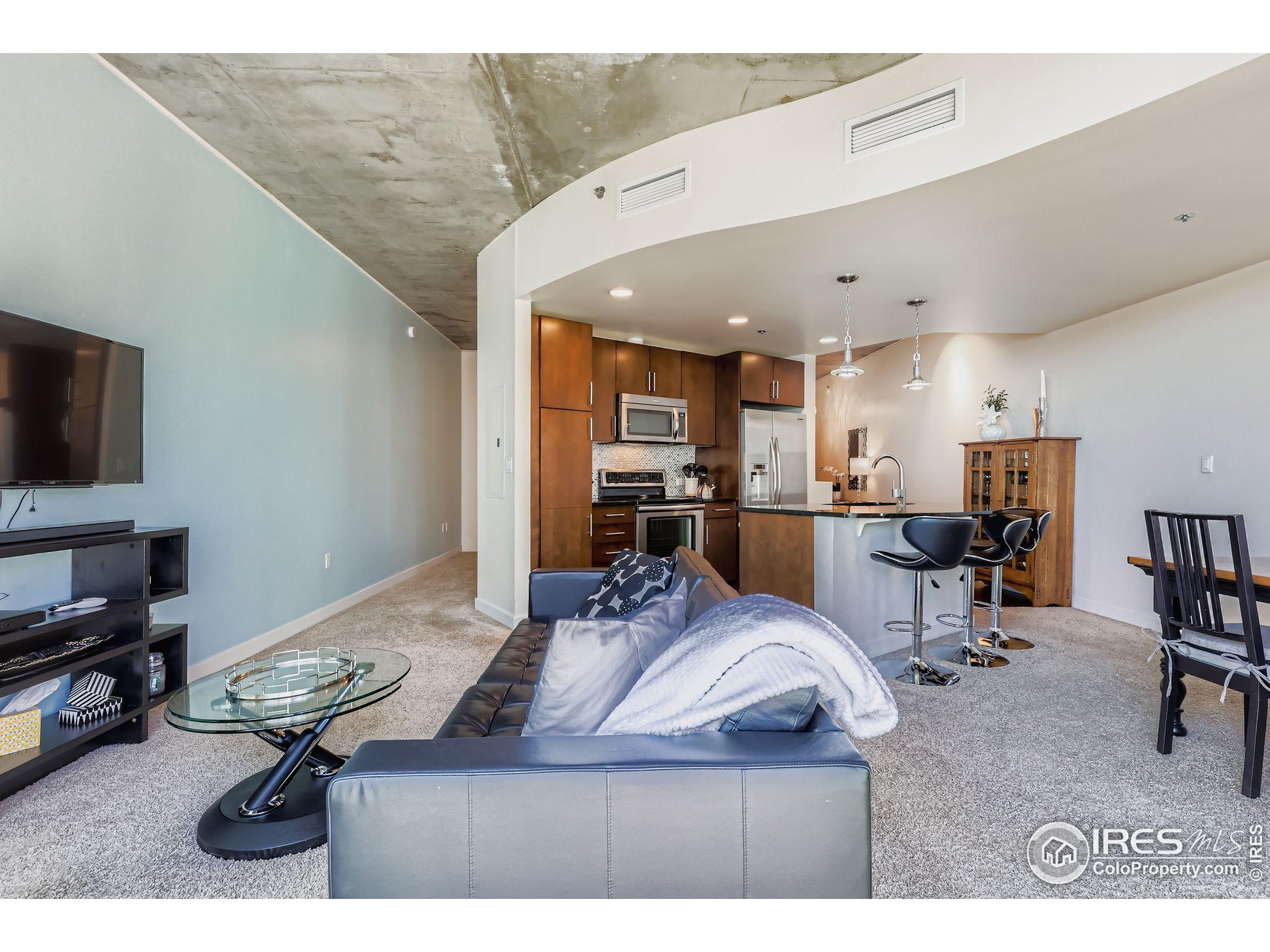 891 14th Street, Unit 1111 Denver, CO 80202 - Photo 8 of 38 a living room with furniture and a flat screen tv