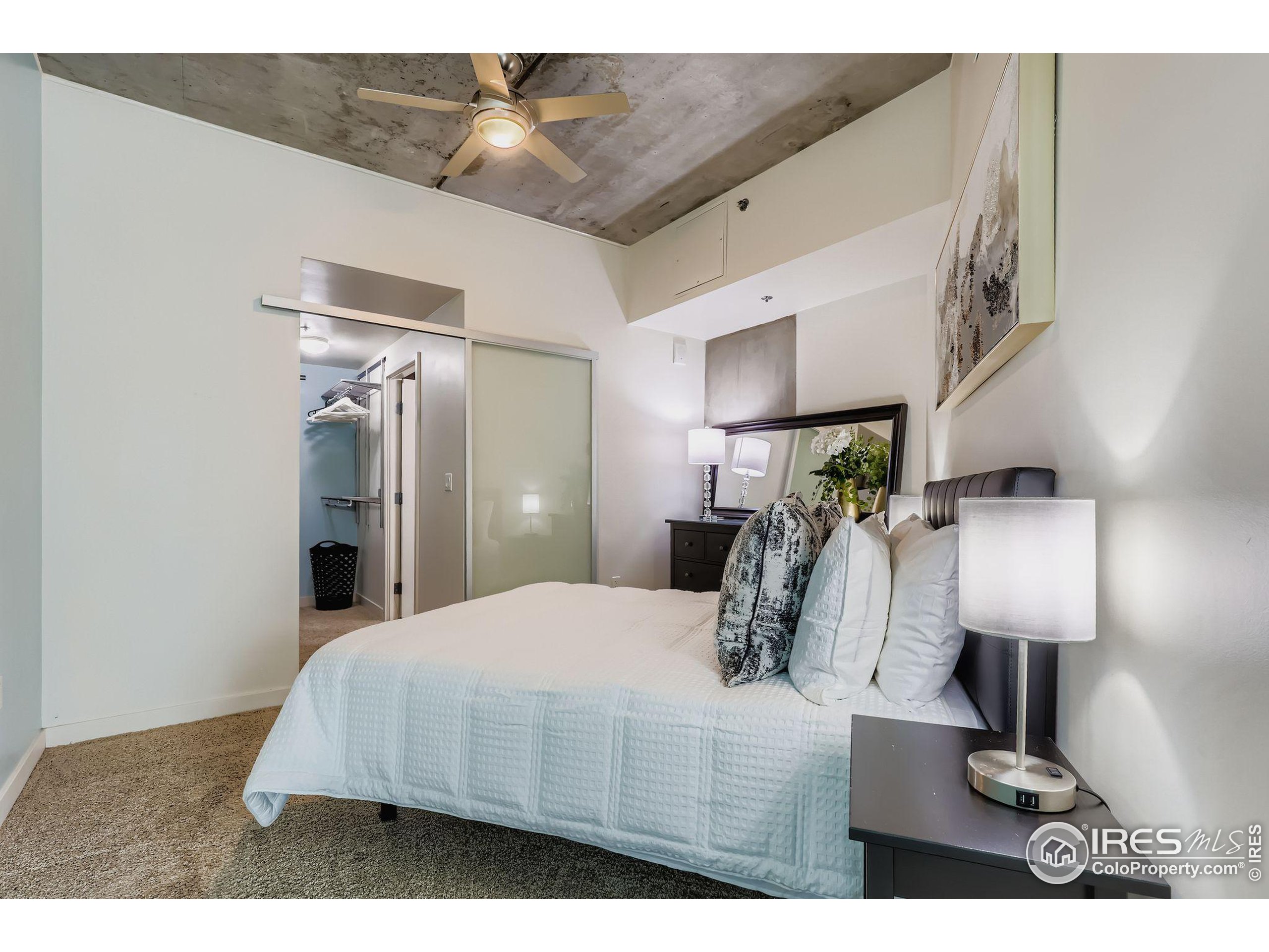 891 14th Street, Unit 1111 Denver, CO 80202 - Photo 10 of 38 a bedroom with a bed and a lamp