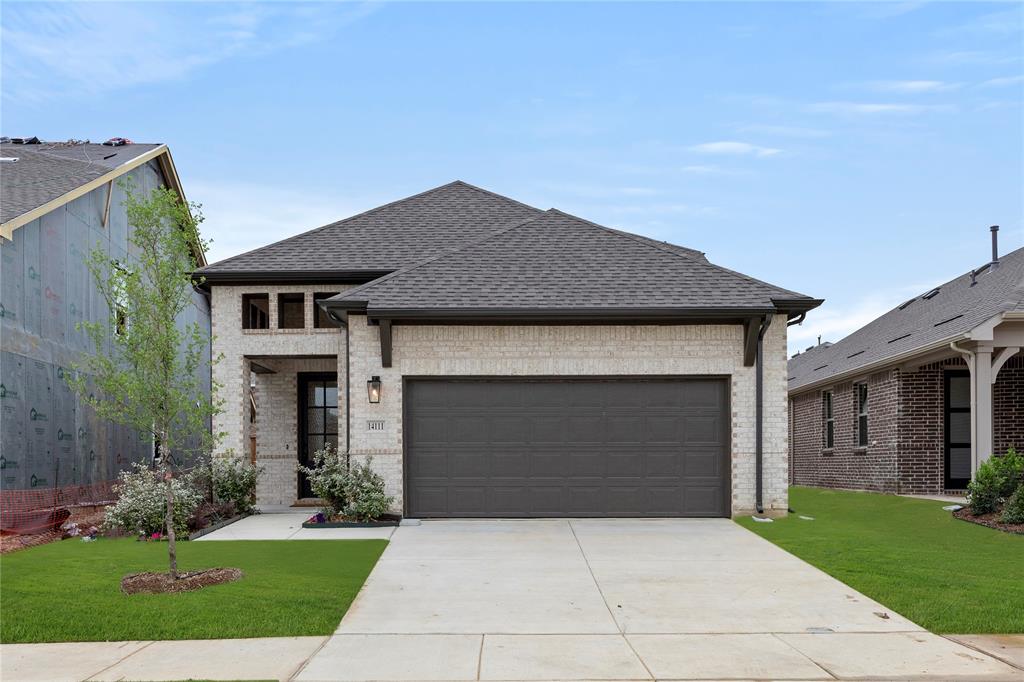 14111 Gallatin Street Pilot Point, TX 76258 - Photo 1 of 1 a front view of a house with a garden and yard