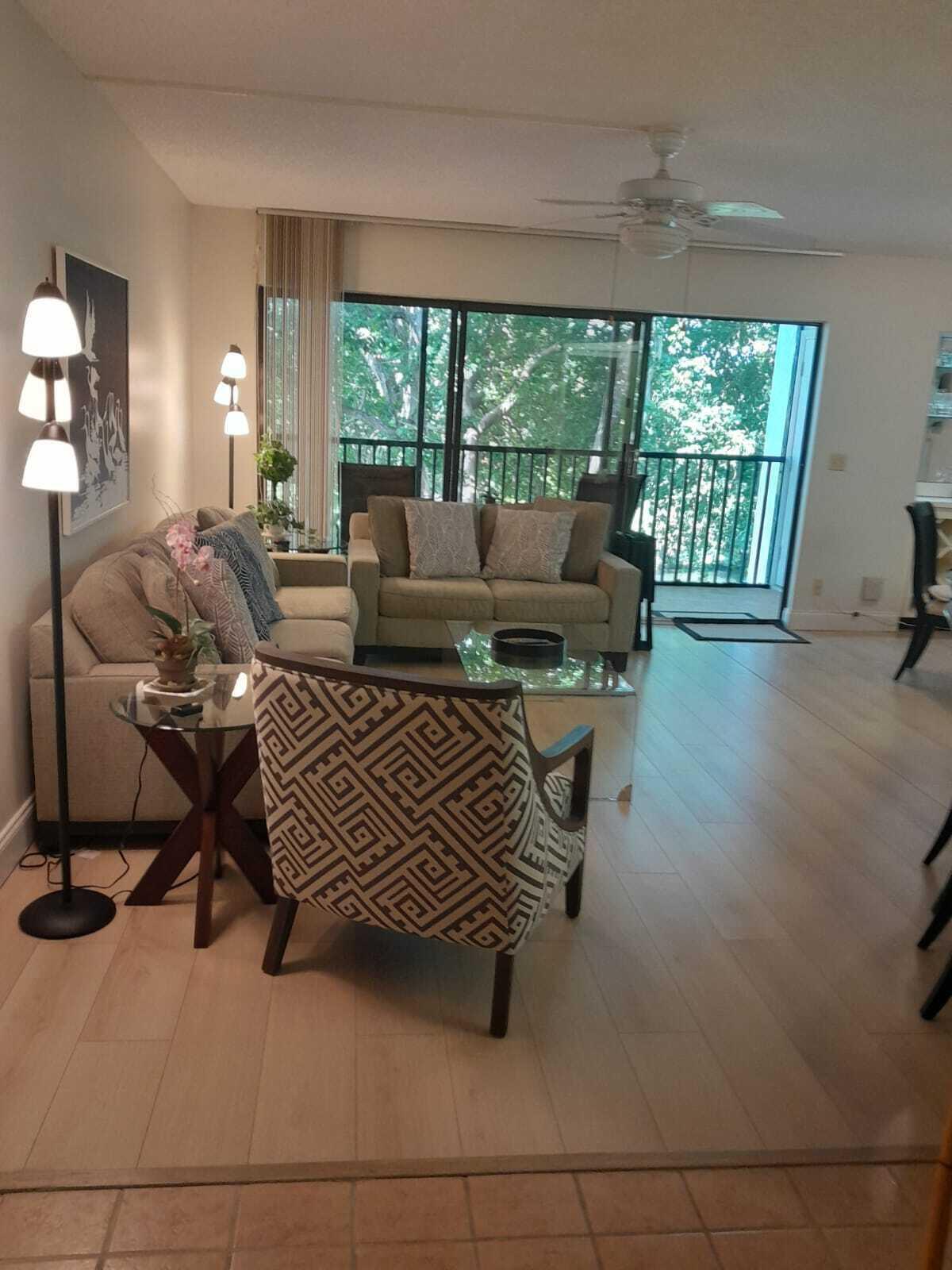 1605 Highway 1, Unit C302 Jupiter, FL 33477 - Photo 4 of 30 a living room with furniture and a floor to ceiling window