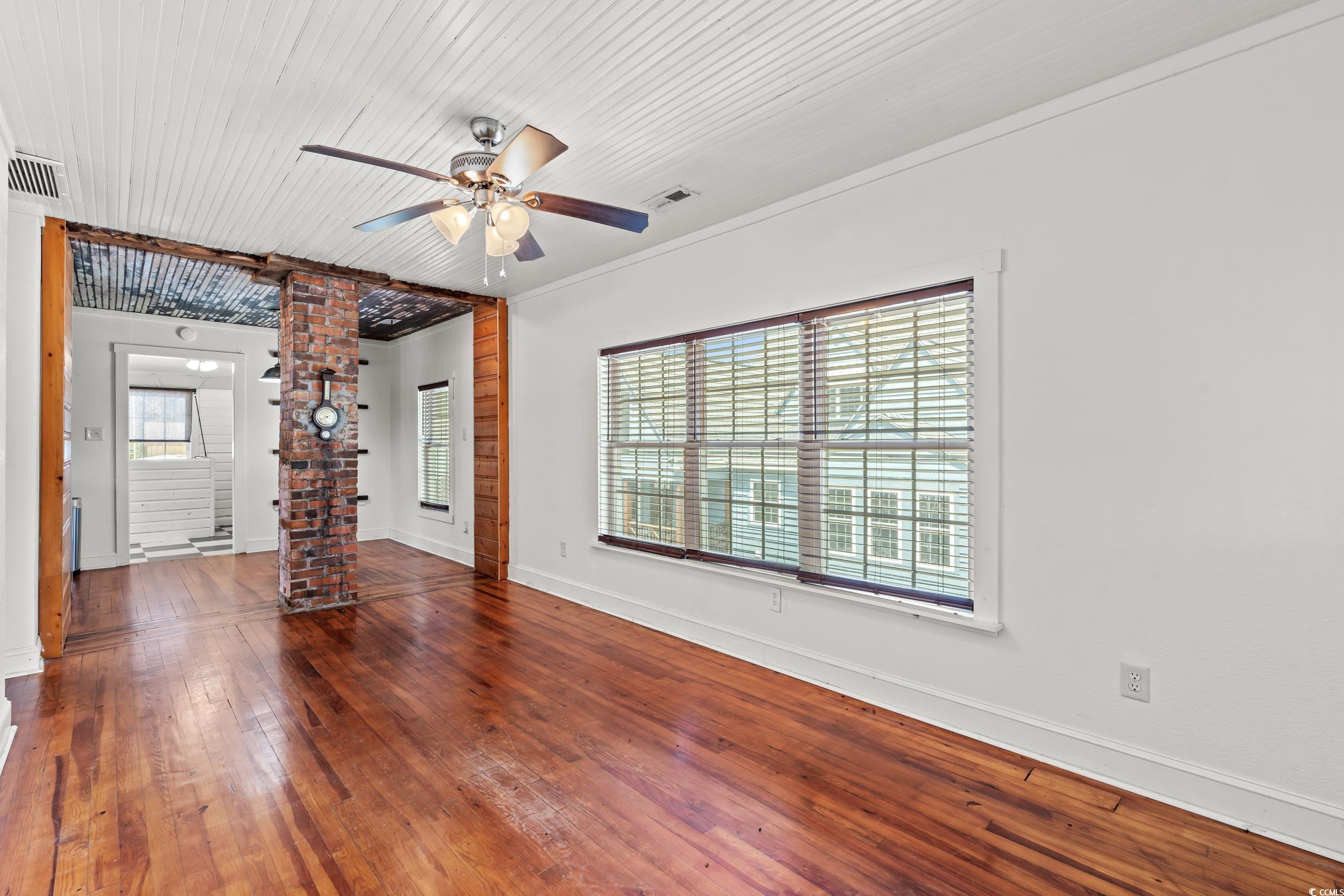 4842 Main Street Loris, SC 29569 - Photo 28 of 40 Unfurnished living room with a wealth of natural l