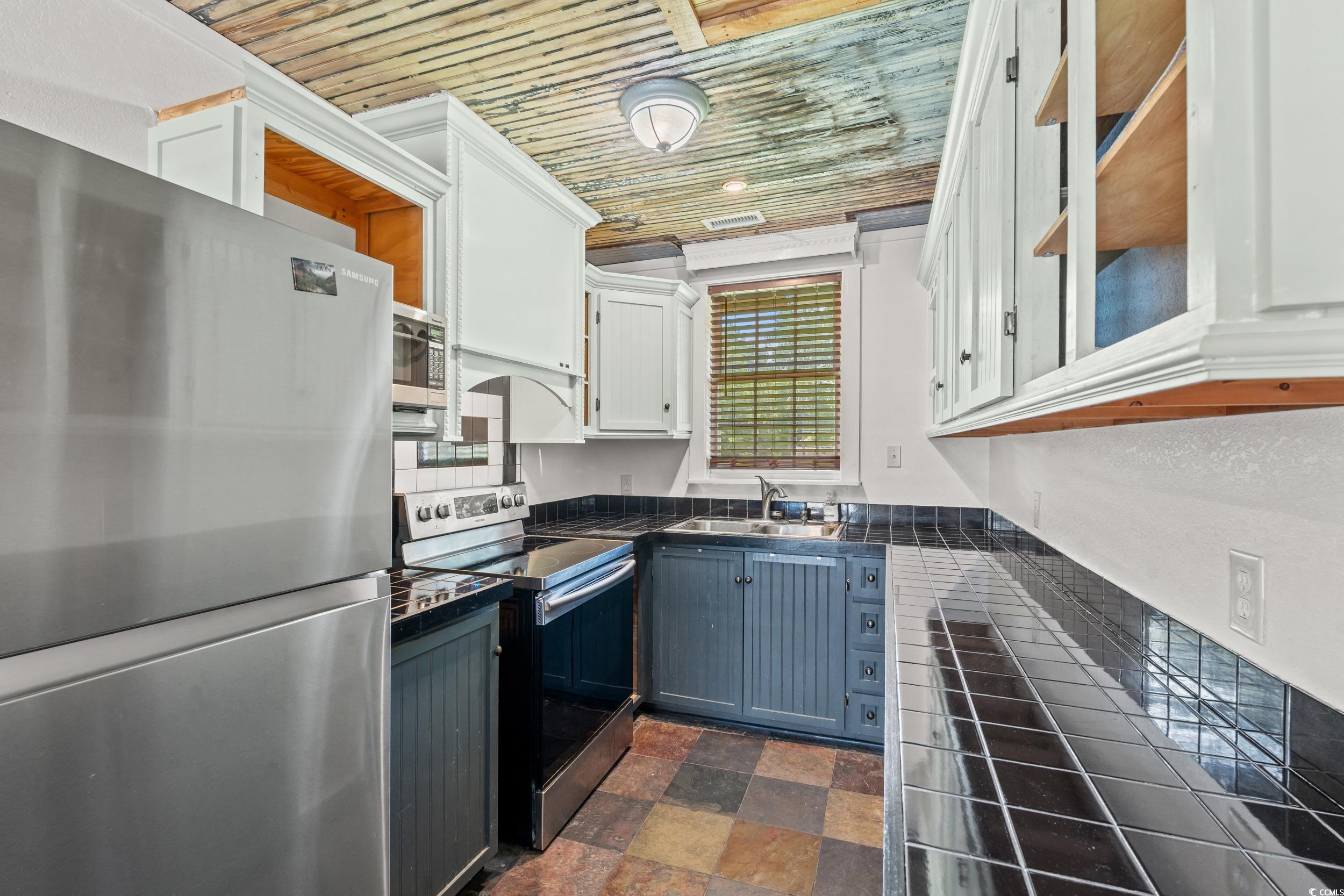 4842 Main Street Loris, SC 29569 - Photo 29 of 40 Kitchen featuring wood ceiling, sink, stainless st