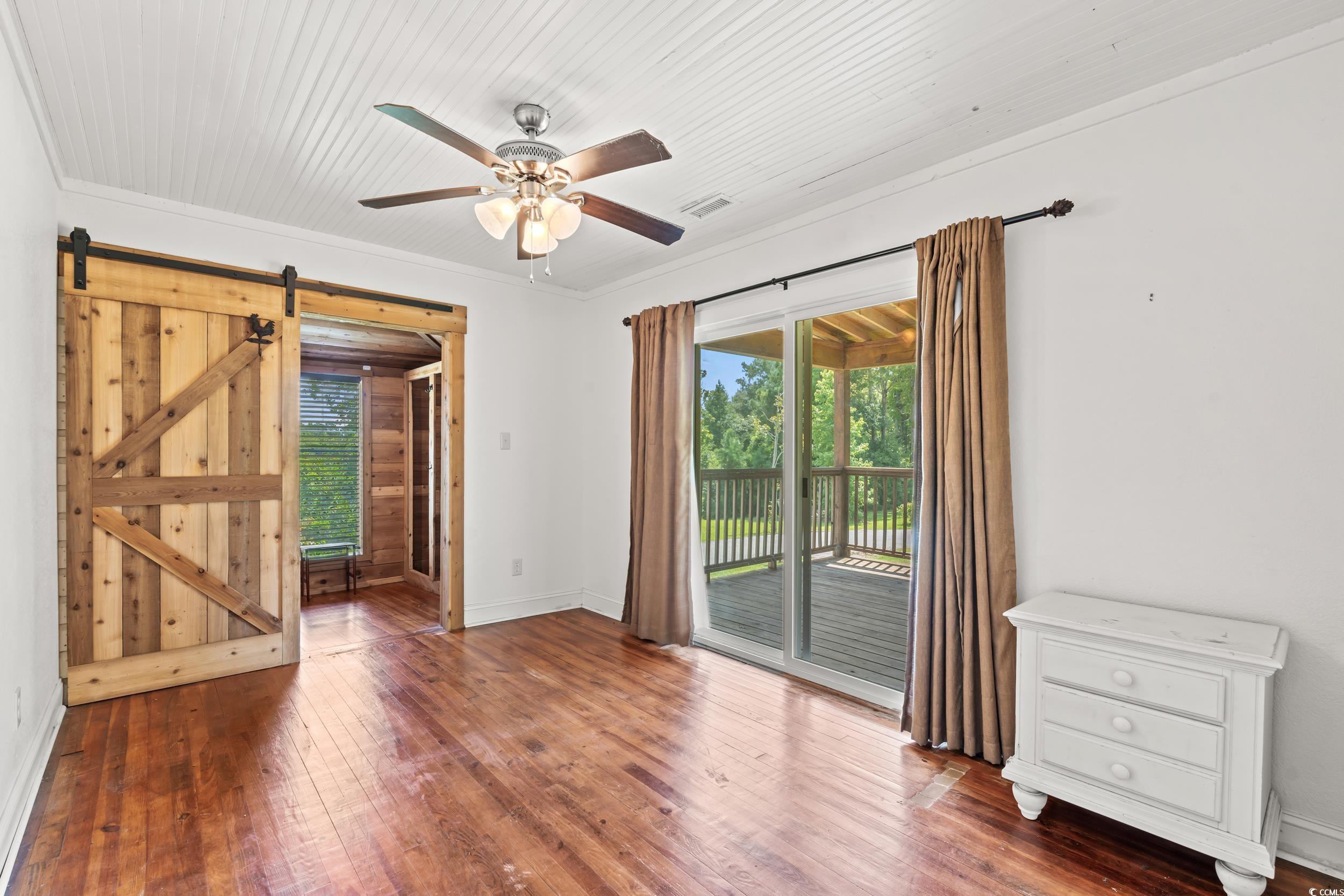 4842 Main Street Loris, SC 29569 - Photo 31 of 40 Featuring crown molding, a barn door, ceiling fan,