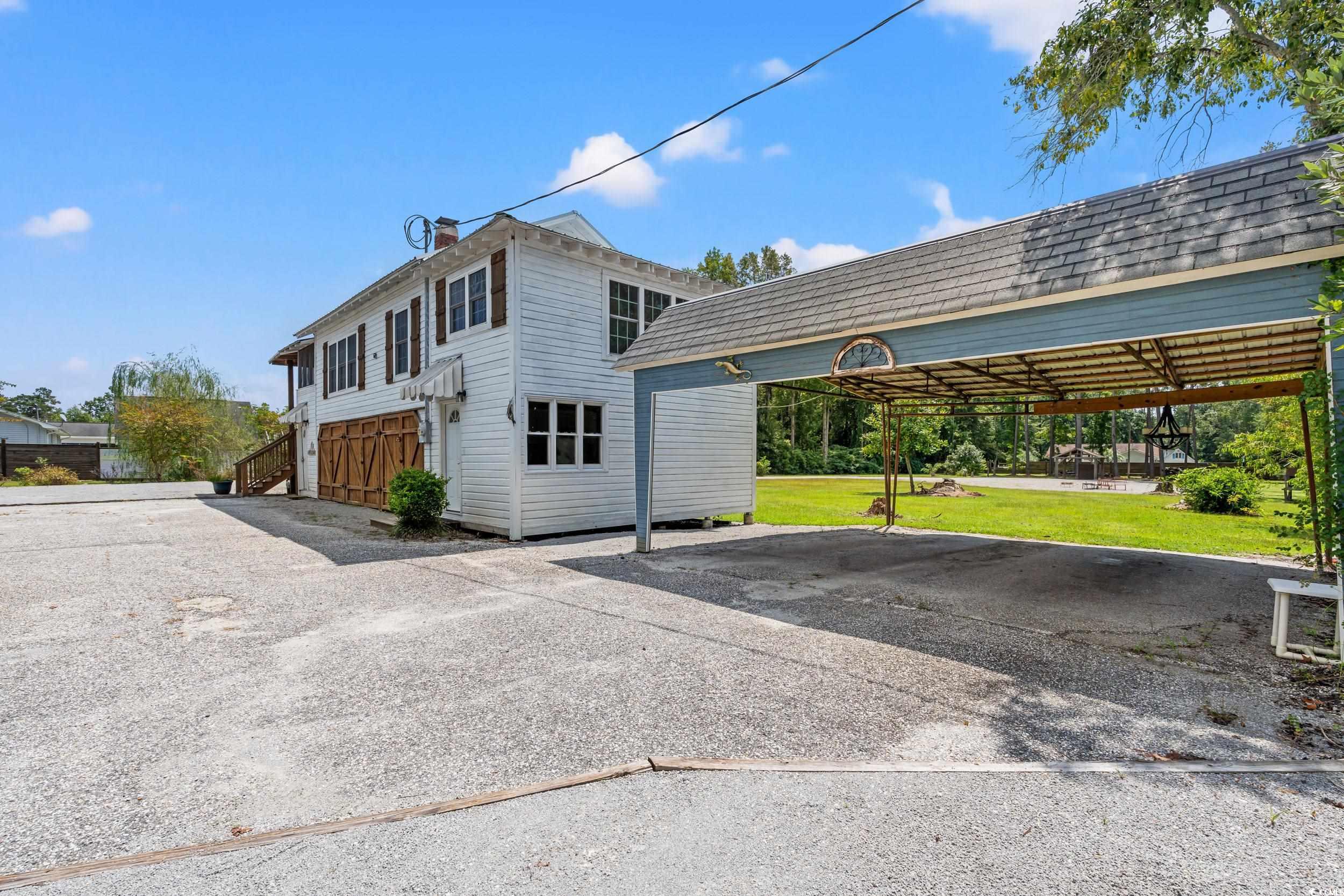 4842 Main Street Loris, SC 29569 - Photo 34 of 40 View of property exterior featuring a yard and a c