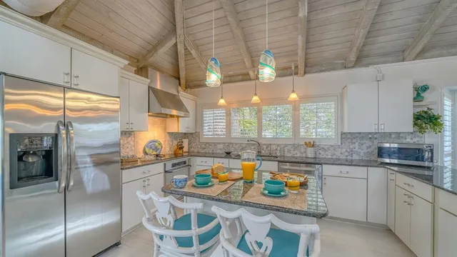 a kitchen with stainless steel appliances granite countertop a sink and cabinets