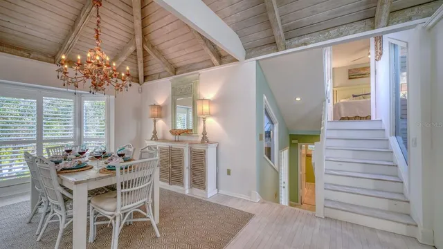 a dining room with furniture and chandelier