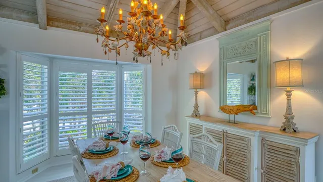 a view of a dining room with furniture and chandelier