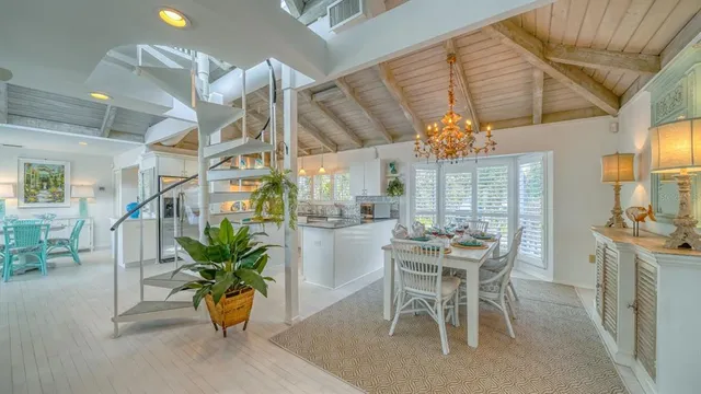 a dining room filled with furniture and chandelier