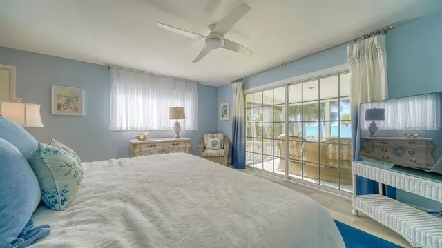 a bedroom with a bed and a dresser next to a window