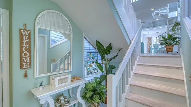 a vase of flowers sitting on a floor next to a window
