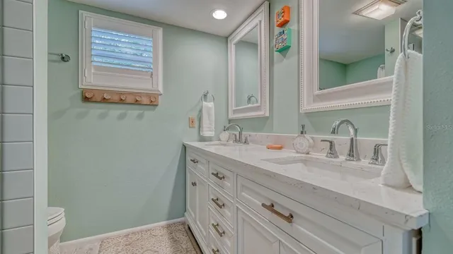 a living room with a bed furniture and a large window