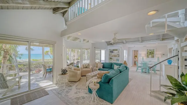 a living room with furniture and a floor to ceiling window